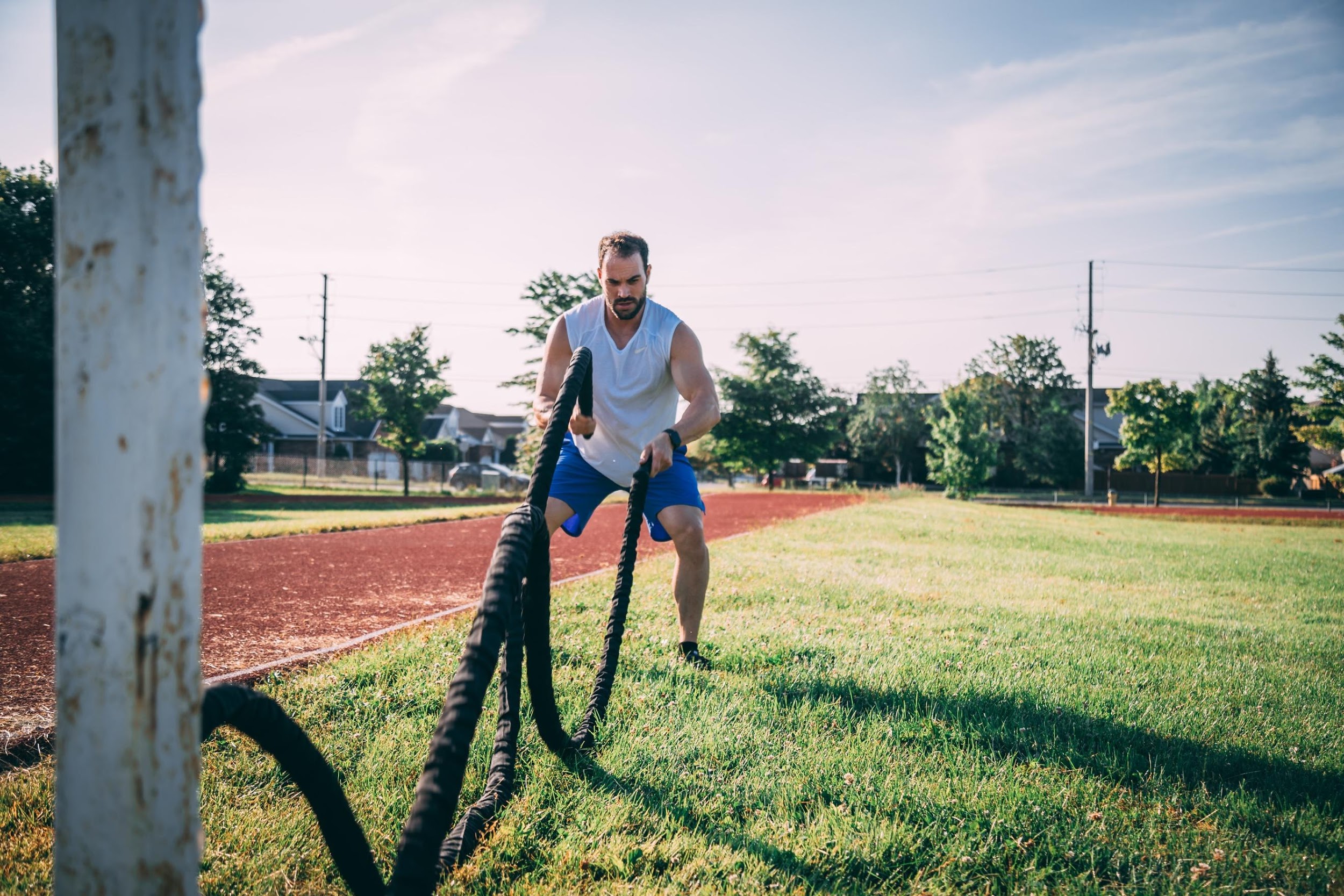 Man doing battling rope exercise outdoors